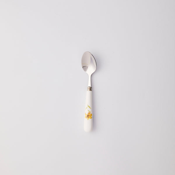 Silver spoon with white and yellow flower handle.
