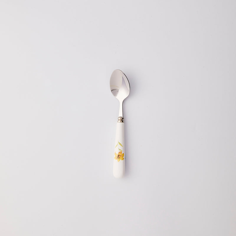 Silver spoon with white and yellow flower handle.