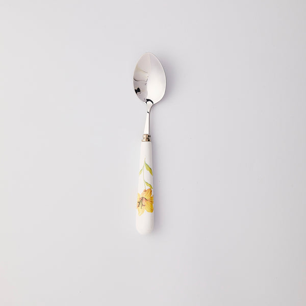 Silver spoon with white and yellow flower handle. 