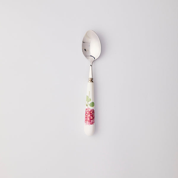 Silver spoon with white and pink handle. 