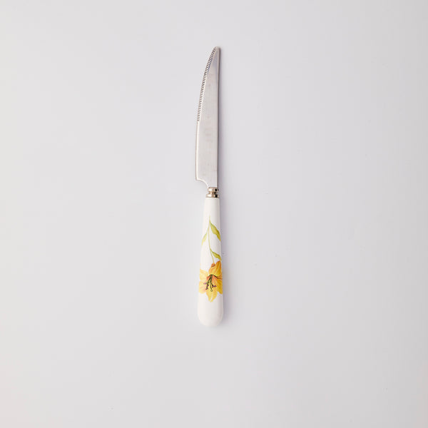 Silver knife with white and yellow handle. 