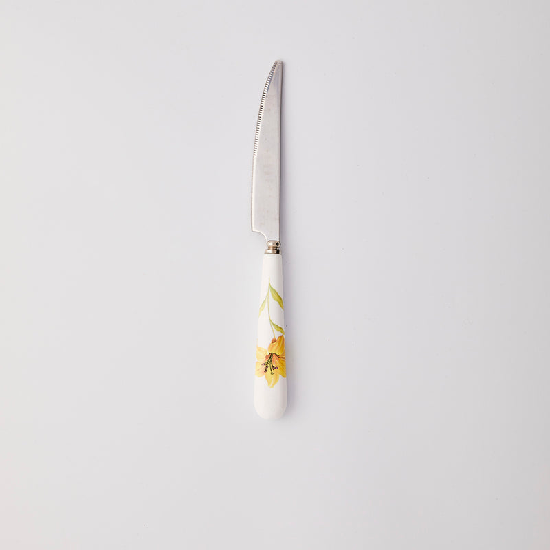 Silver knife with white and yellow handle. 