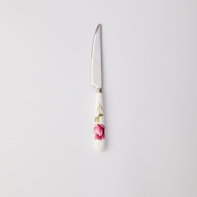 Silver knife with white and pink flower handle. 