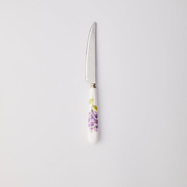 Silver knife with white and purple handle. 