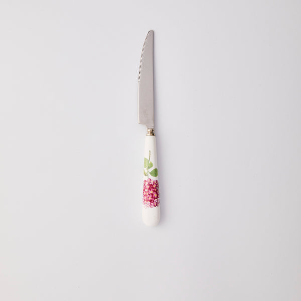 Silver knife with white and pink handle. 