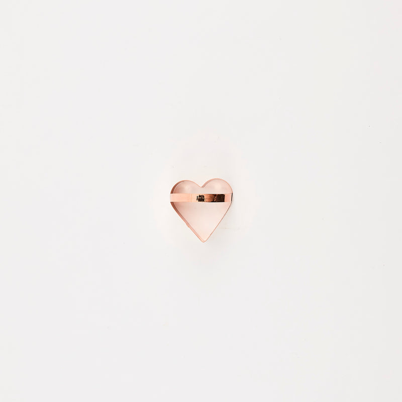 Rose gold heart cutter with handle.