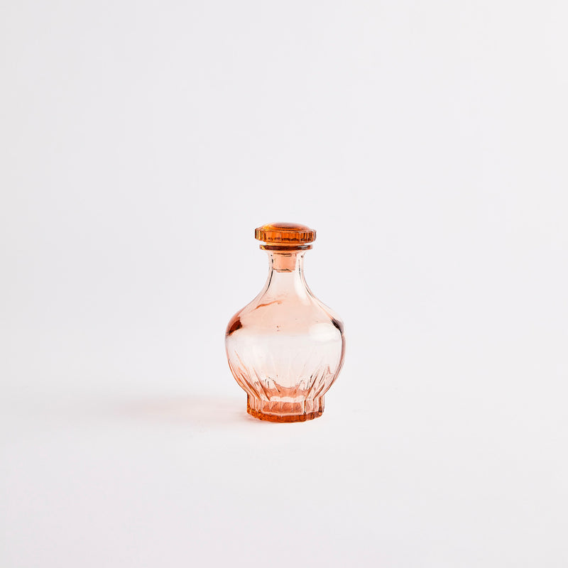 Peach glass decanter.