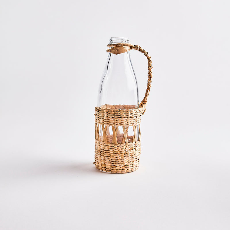 Clear glass decanter with wicker case. 