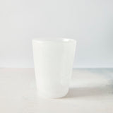 Frosted white glass tumbler.