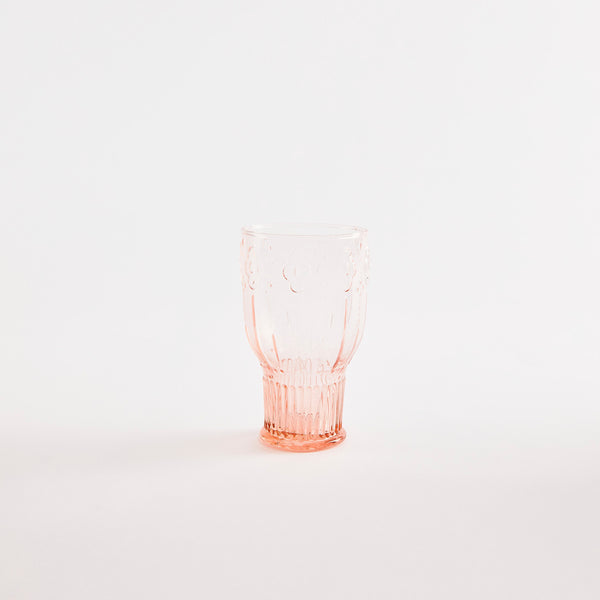 Pink glass tumbler with embossed design.