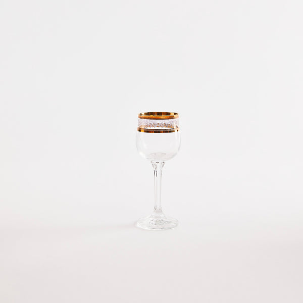 Clear glass goblet with gold rim.