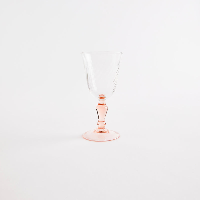 Clear glass with pink stem.