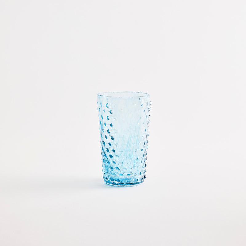 Blue collins glass with embossed design.