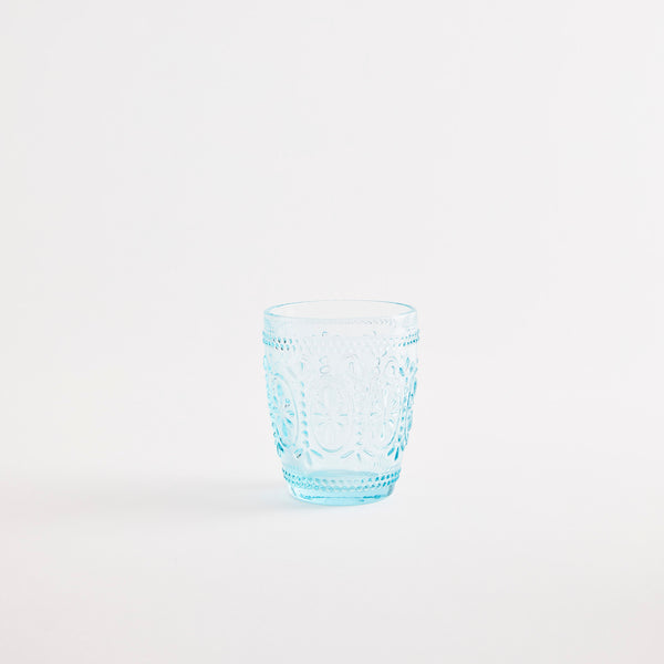 Blue glass tumbler with embossed design.