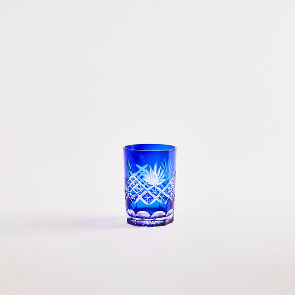 Blue glass tumbler with etched design.