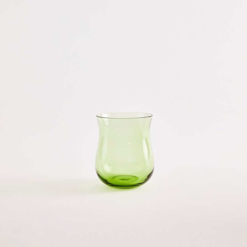 Green glass tumbler.