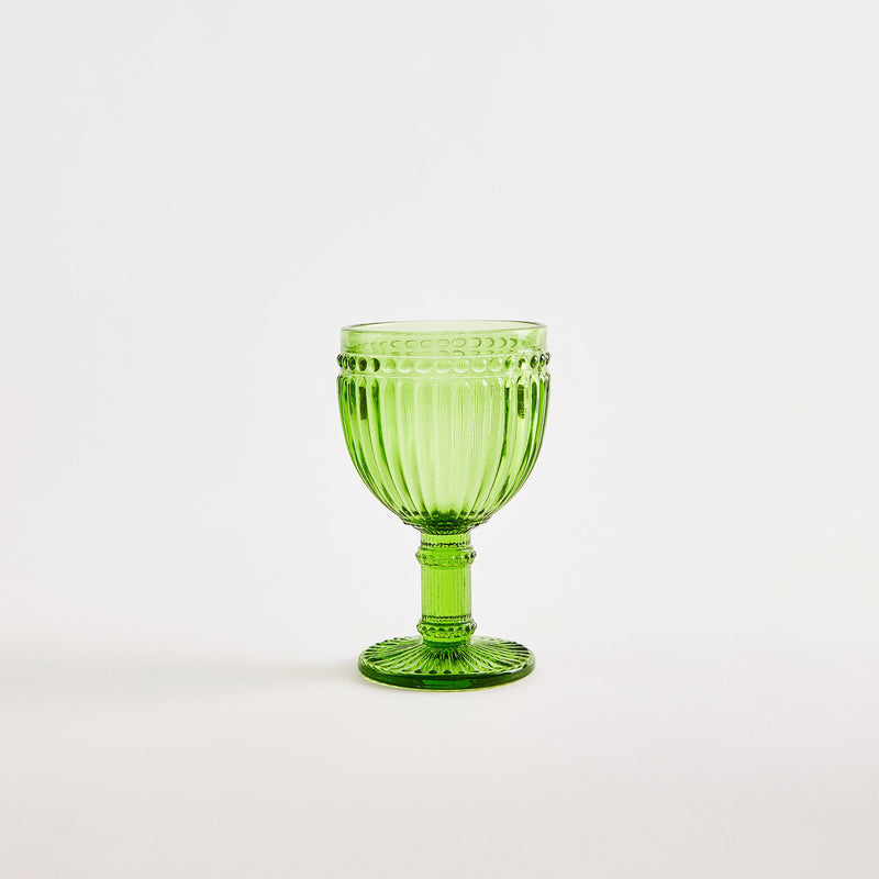 Green glass goblet with embossed design.