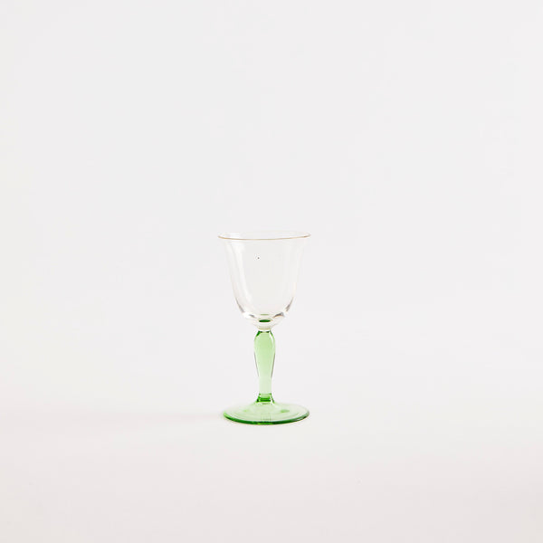 Clear wine glass with green base.