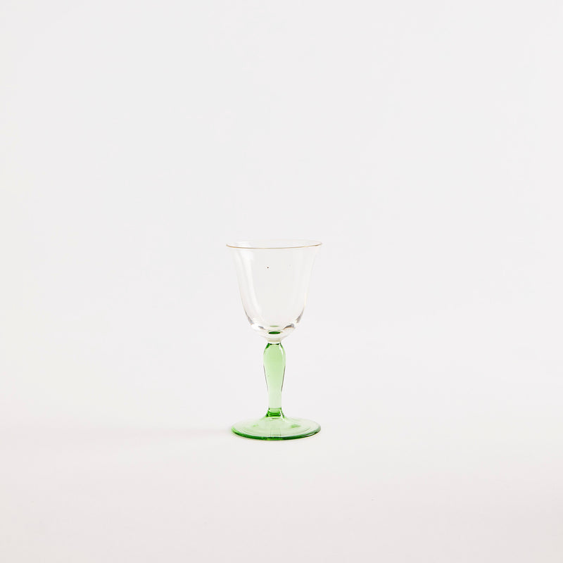 Clear wine glass with green base.
