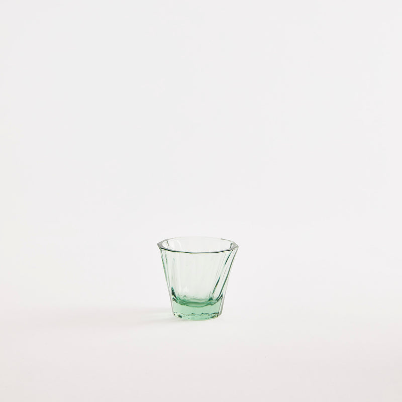 Small green glass tumbler.