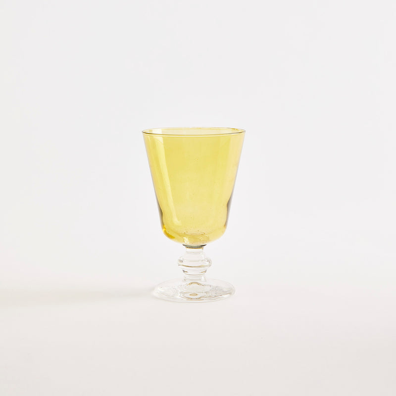 Yellow glass goblet with clear base.