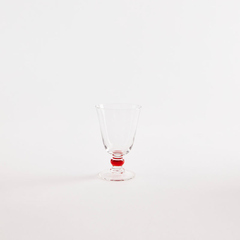 Clear glass goblet with red base.