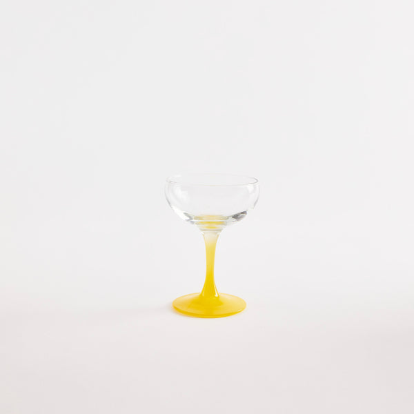 Clear glass coupe with yellow base.