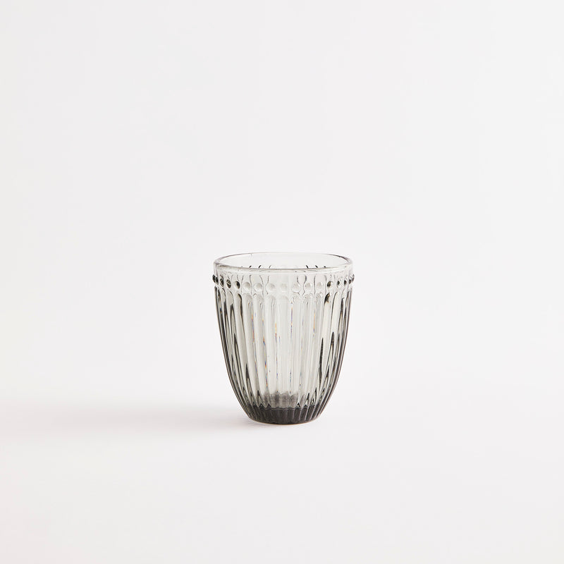 Grey glass tumbler.