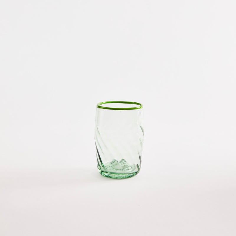 Green glass tumbler.