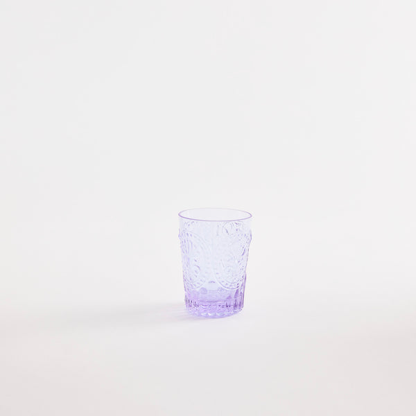Purple glass tumbler with embossed design.