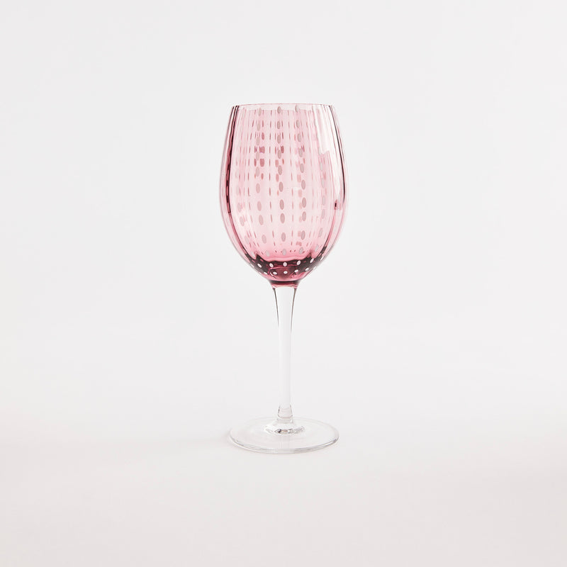 Purple with white dotted design wine glass with clear stem.