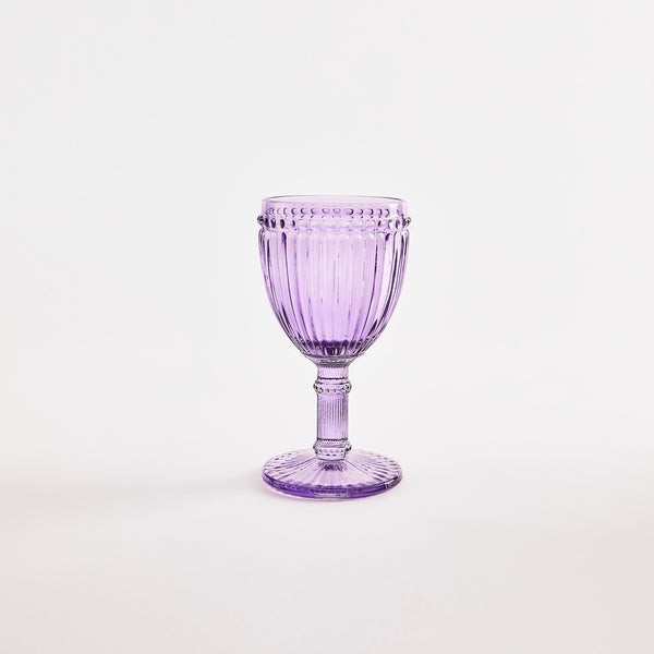 Purple glass goblet with embossed design.