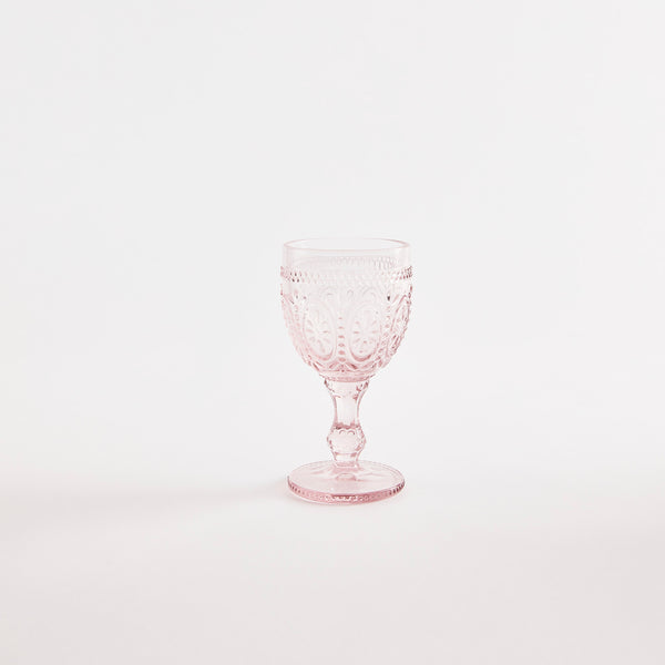 Pink glass goblet with embossed design.