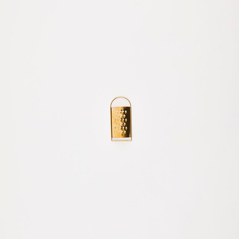 Gold grater with handle.