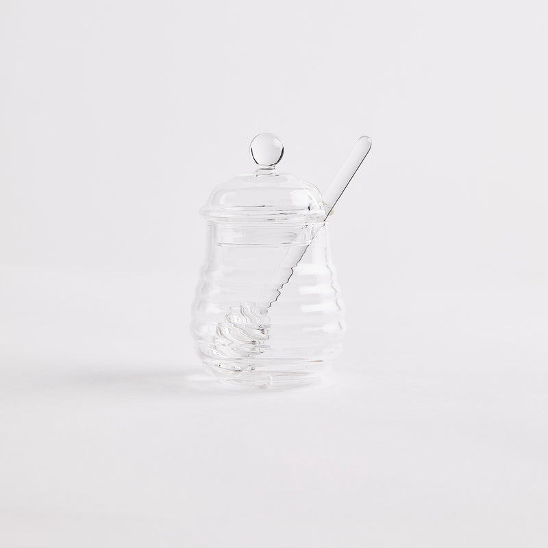 Clear glass honey pot with glass stick. 