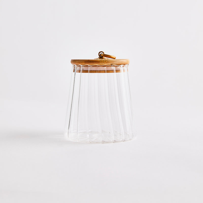 Clear glass honey pot with wooden lid.