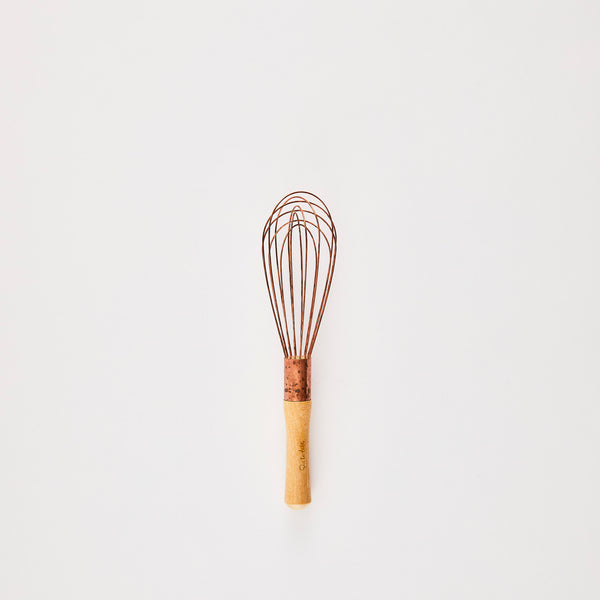 Copper whisk with wooden handle.