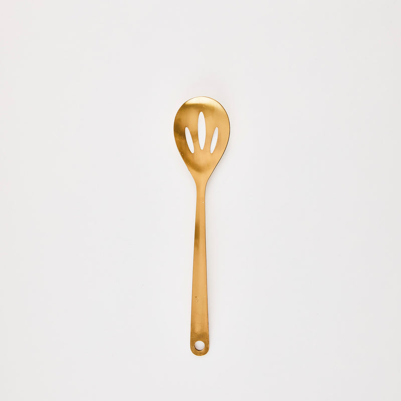 Gold slotted kitchen spoon.