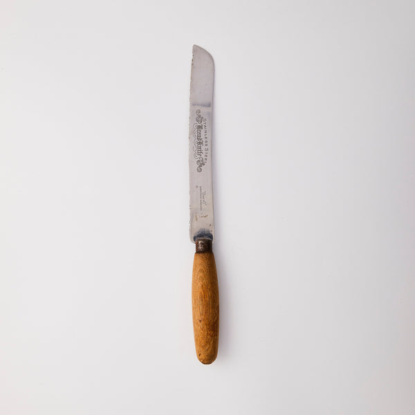 Silver knife with wood handle.
