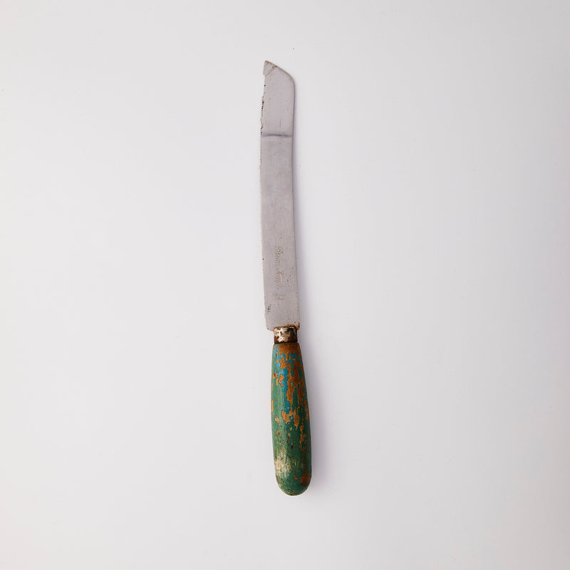 Silver knife with green handle.