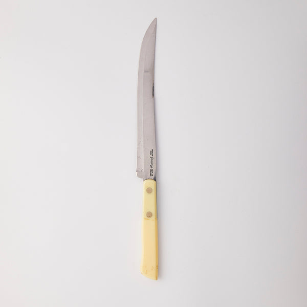 Silver knife with yellow handle.