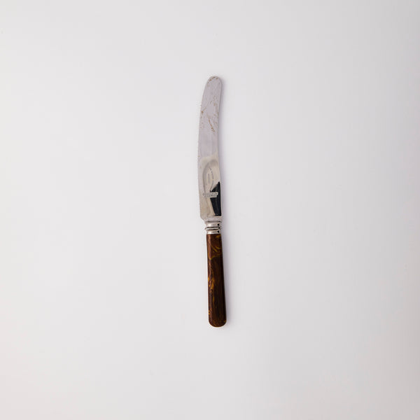 Silver knife with brown handle.