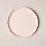 Light pink with curved edge charger plate.