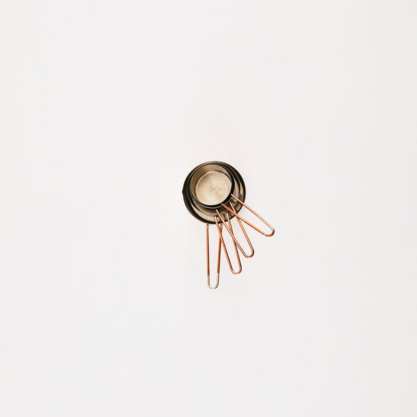 Silver and copper measuring cups.