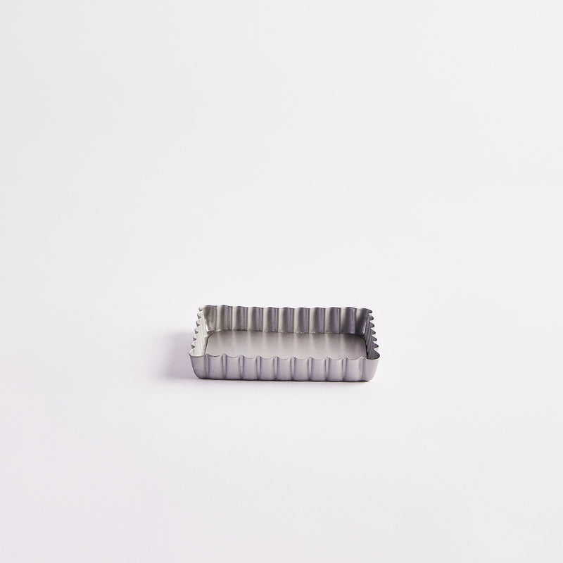 Silver rectangular mini flan case.