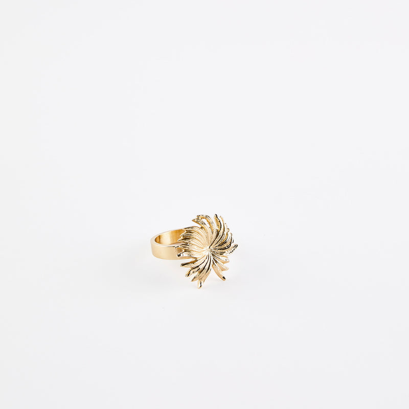 Gold napkin ring with gold flower.