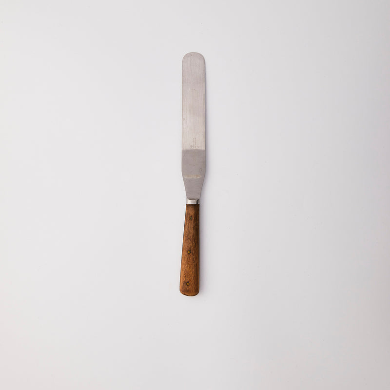 Silver palette knife with wood handle.