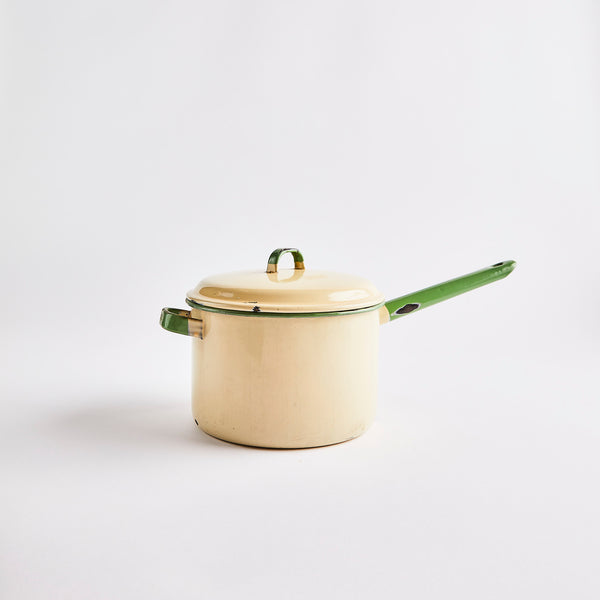 Cream pan and lid with green handles.