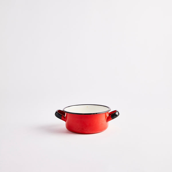 Red pot with black handles.
