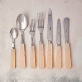 Silver with peach handle cutlery.